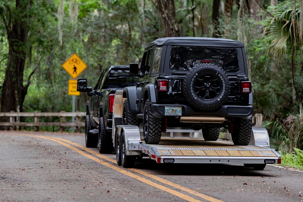 Open Wood Deck Car Hauler Driving